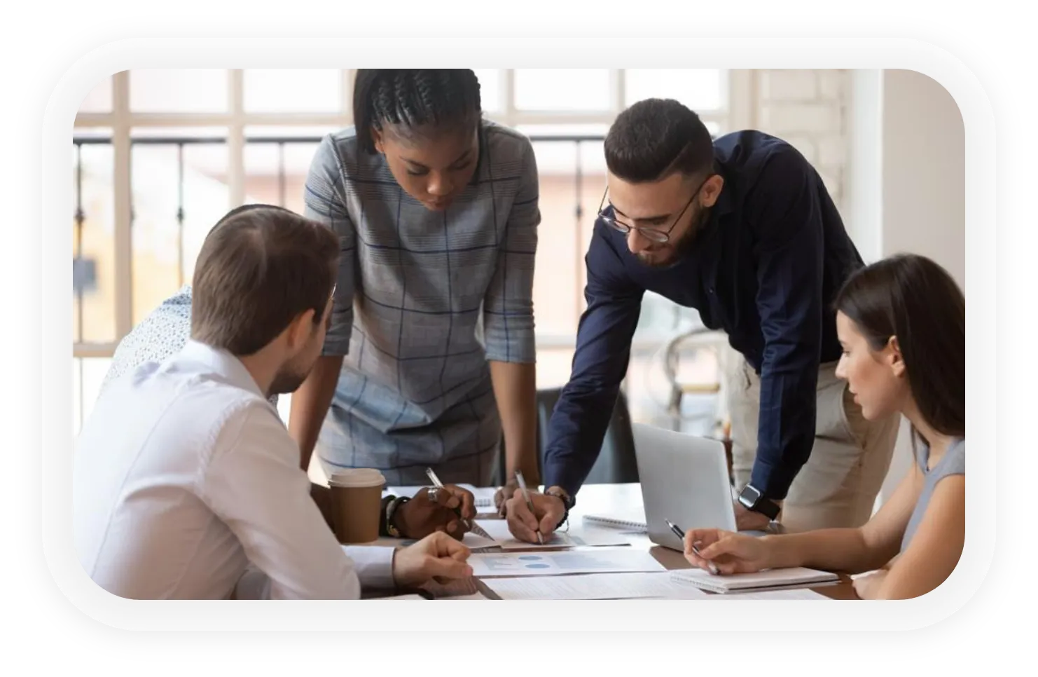 4 people having meeting on office table